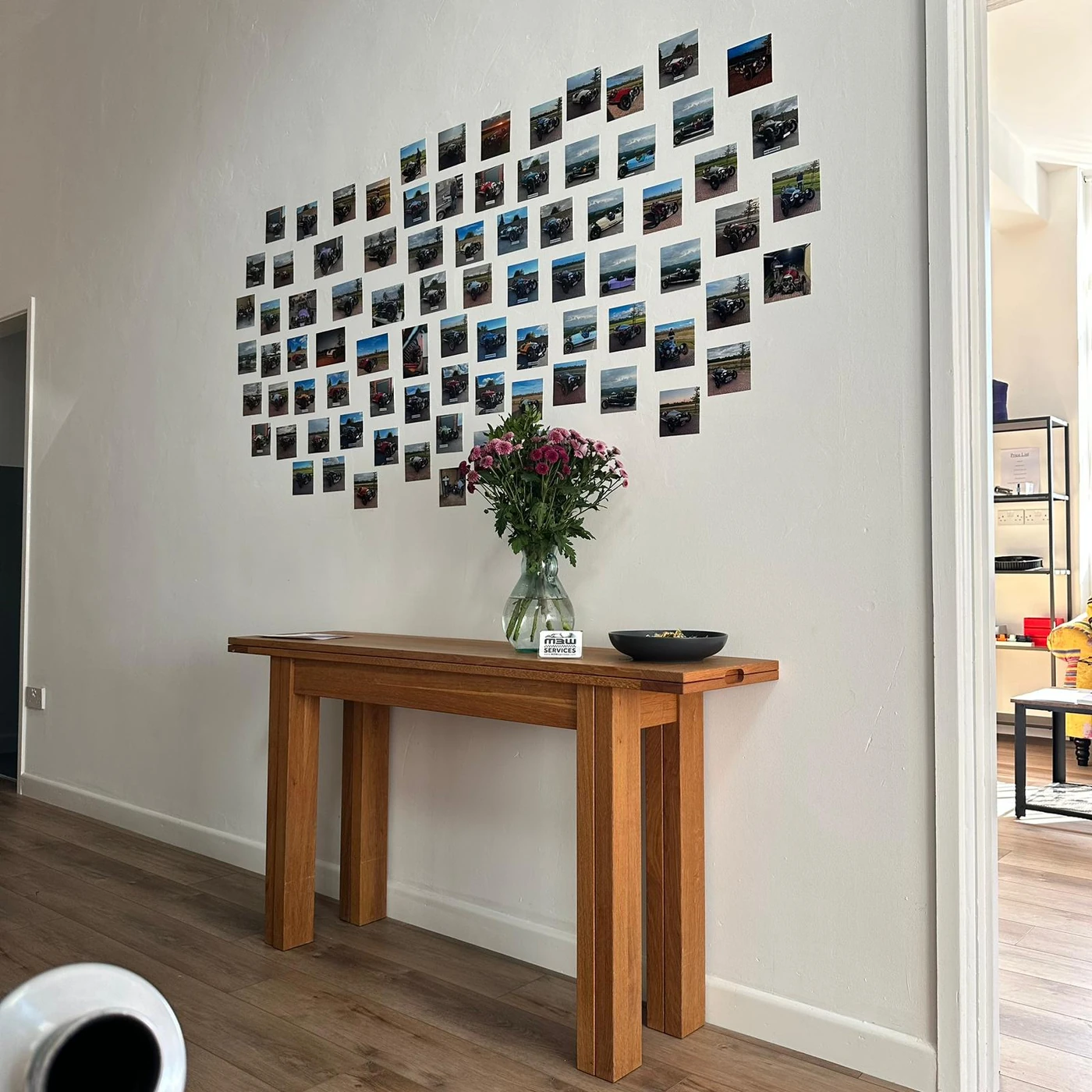 Wall of customer photographs inside the M3W Services UK workshop