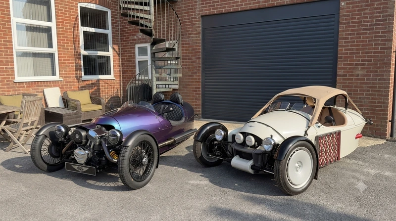 Classic Morgan 3-Wheeler parked alongside a Morgan Super 3