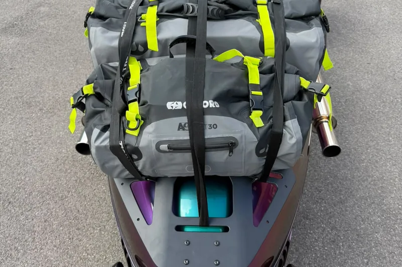 The luggage rack loaded with a strapped drybag, seen from above