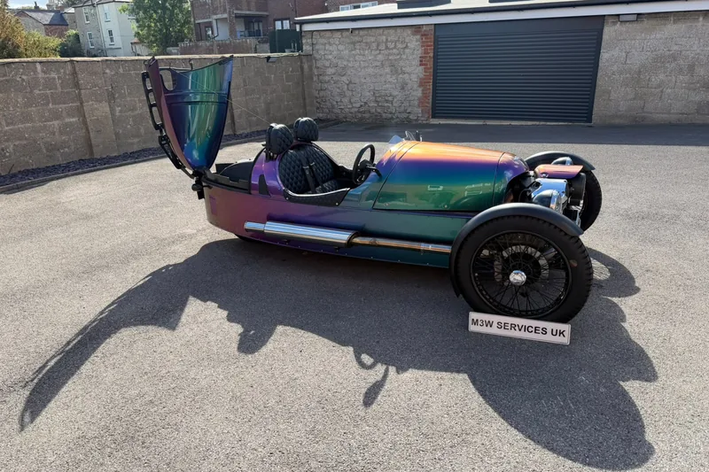 Full side profile of a Morgan 3 Wheeler with the luggage rack fitted