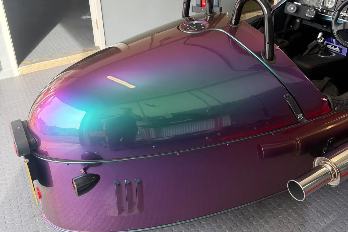 The bare rear deck of a Morgan 3 Wheeler, which forms the lid of the storage underneath